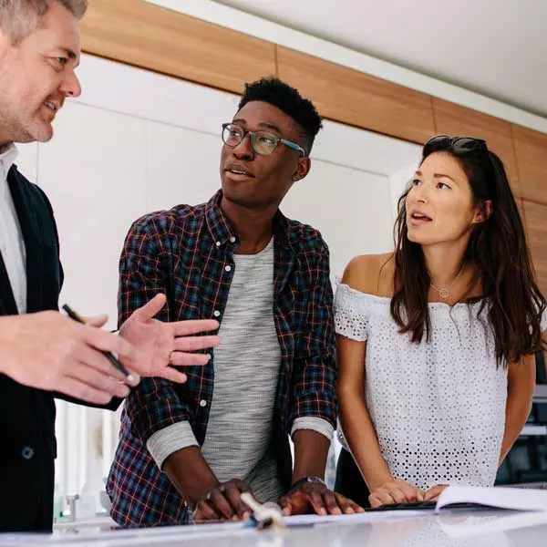 selling a home: real estate agent working with couple